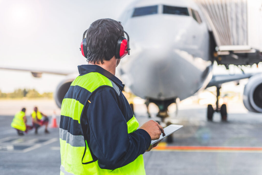 Ground crew preparing aircraft for pilots taking ICAO English test