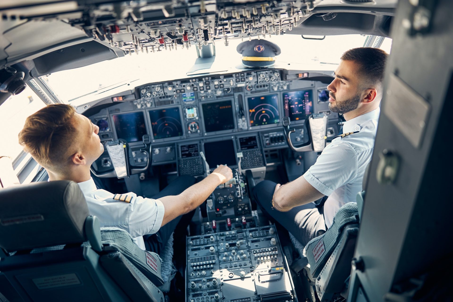 Pilots preparing for ICAO English test during flight simulation